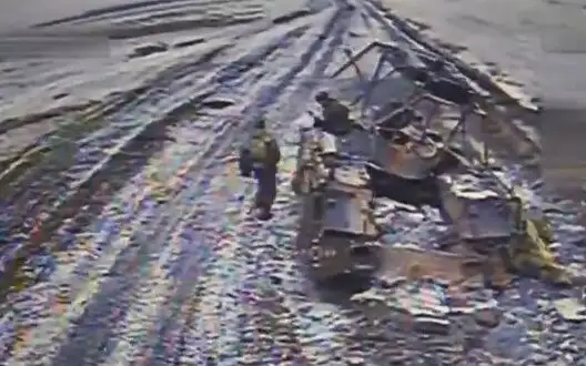 Pair of Russians in snowy field circling around hit IFV-3 under sights of Ukrainian kamikaze drone. VIDEO