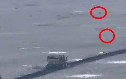 Ukrainian drones hover over enemy tank racing down field road. VIDEO