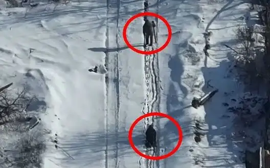 One occupier walking with crosier, while other crawling on all fours on snowy road near Chasiv Yar. VIDEO