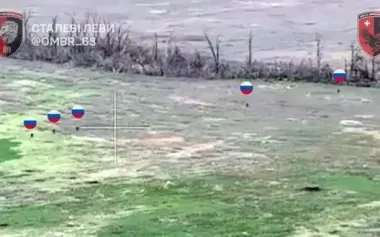 Five occupiers in full growth walking across open field to storm Ukrainian positions. VIDEO