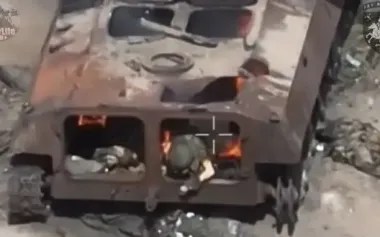 Engulfed in flames, occupier trying in vain to climb out of burning armoured vehicle. VIDEO 18+