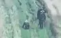 Two occupiers walking past their wounded accomplice, who is crawling towards them on all fours. VIDEO