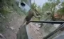 Wounded occupier, shot in buttocks, limps away after evacuation to shelter. VIDEO