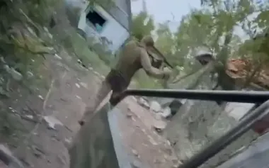 Wounded occupier, shot in buttocks, limps away after evacuation to shelter. VIDEO