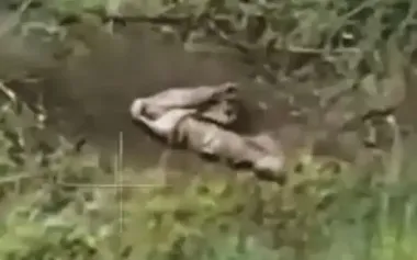 Russian soldier on battlefield shoots himself in head twice with automatic rifle. VIDEO
