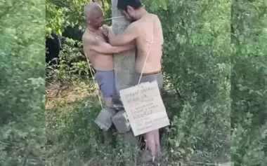 Russian soldier beating two of his comrades tied to pole with stick: "Here they are, two f#ggots! You shouldn’t have left your positions!". VIDEO