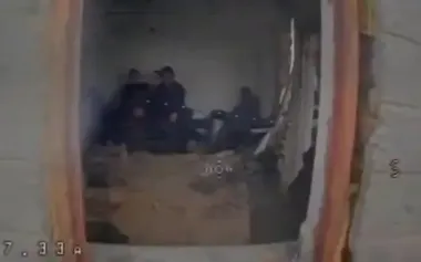 Drone flies through window into room where four occupiers are sitting. VIDEO