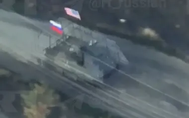 Occupiers hung Russian and American flags on their armoured vehicle and are heading to storm positions of Armed Forces of Ukraine. VIDEO