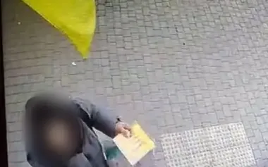 Woman tears down Ukrainian flag and throws it in trash in Odesa. She has been charged. PHOTO