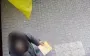 Woman tears down Ukrainian flag and throws it in trash in Odesa. She has been charged. PHOTO