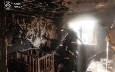 Rescue extinguishes his own apartment, which was burning after Russian UAV strike in Kyiv. PHOTO